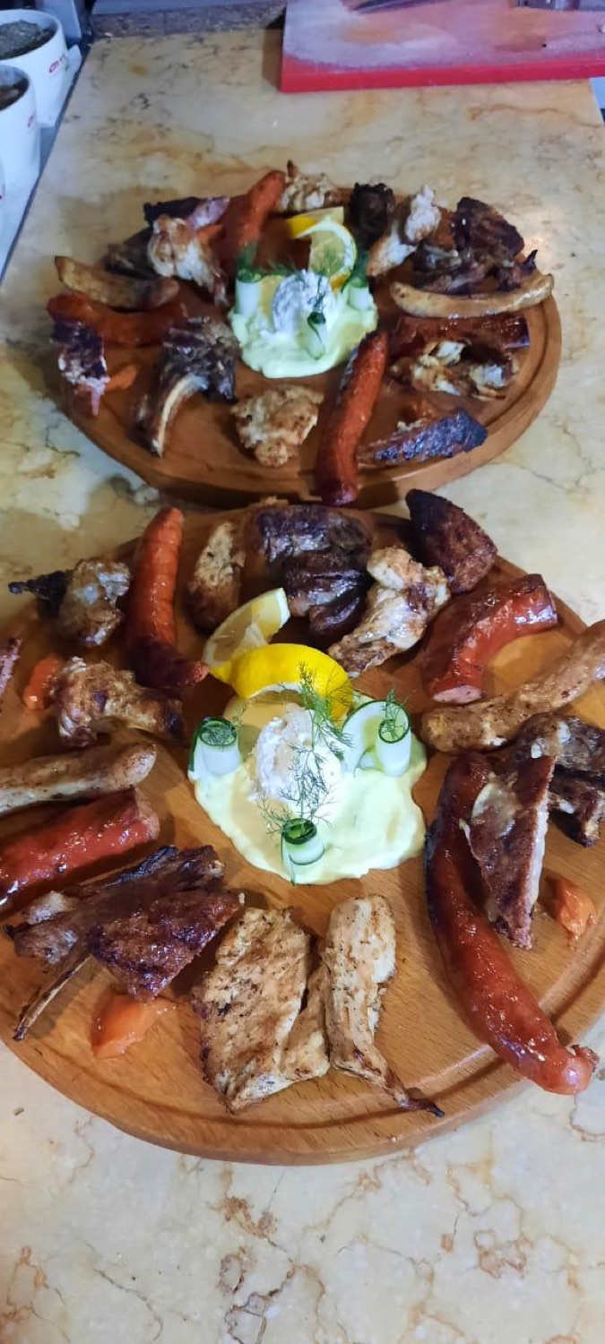 Two loaded mixed-grill boards of chicken, lamb chops and sausage